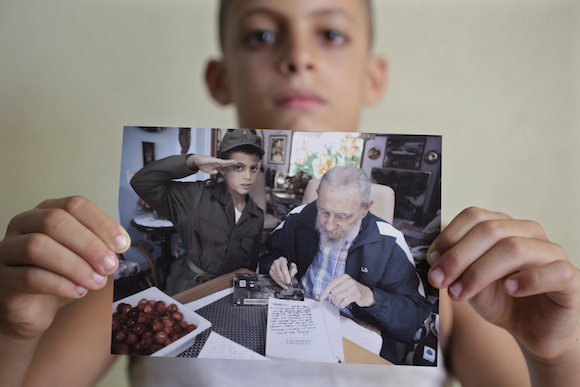 Eight-year-old Marlon Mendez, who claims to be an admirer of Cuba’s former president Fidel Castro, shows a book 